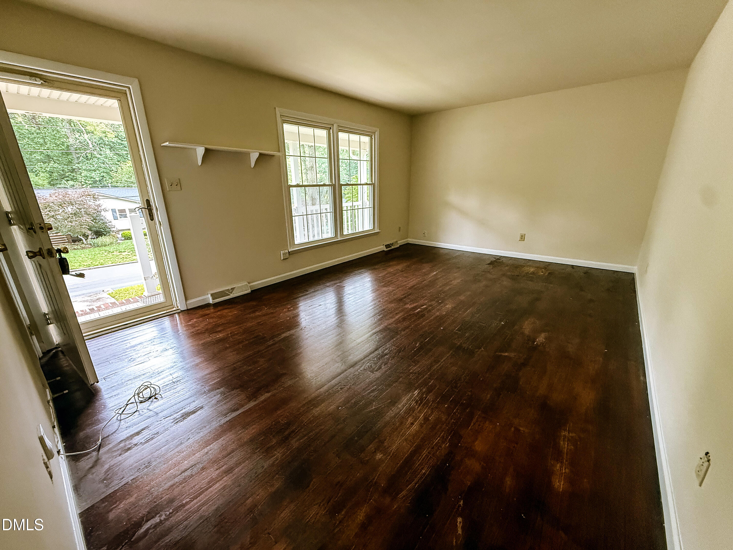 4717 Radcliff Road Raleigh, NC 27609 - Photo 2 of 11 an empty room with wooden floor and windows
