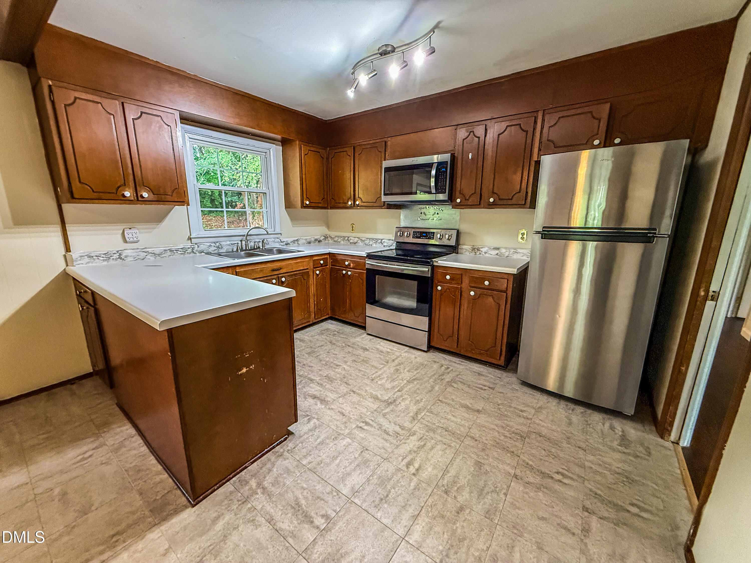 4717 Radcliff Road Raleigh, NC 27609 - Photo 3 of 11 a kitchen with stainless steel appliances granite countertop a refrigerator stove microwave and sink