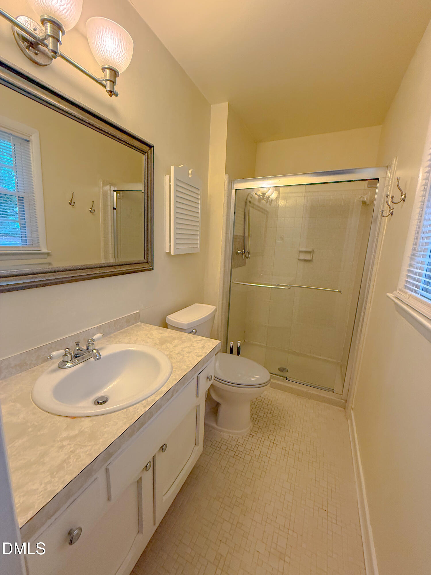 4717 Radcliff Road Raleigh, NC 27609 - Photo 6 of 11 a bathroom with a sink and a mirror