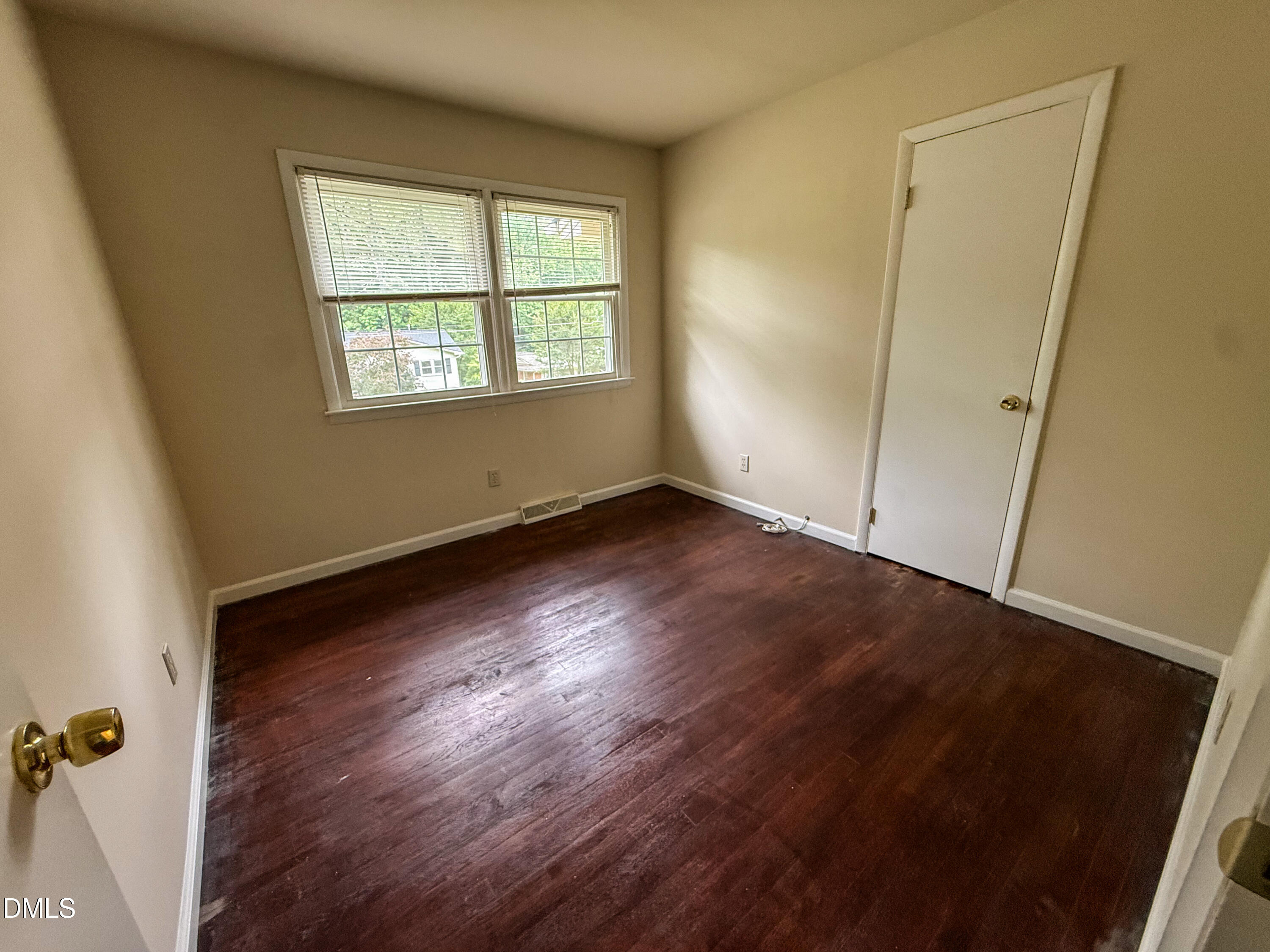 4717 Radcliff Road Raleigh, NC 27609 - Photo 7 of 11 an empty room with wooden floor and windows