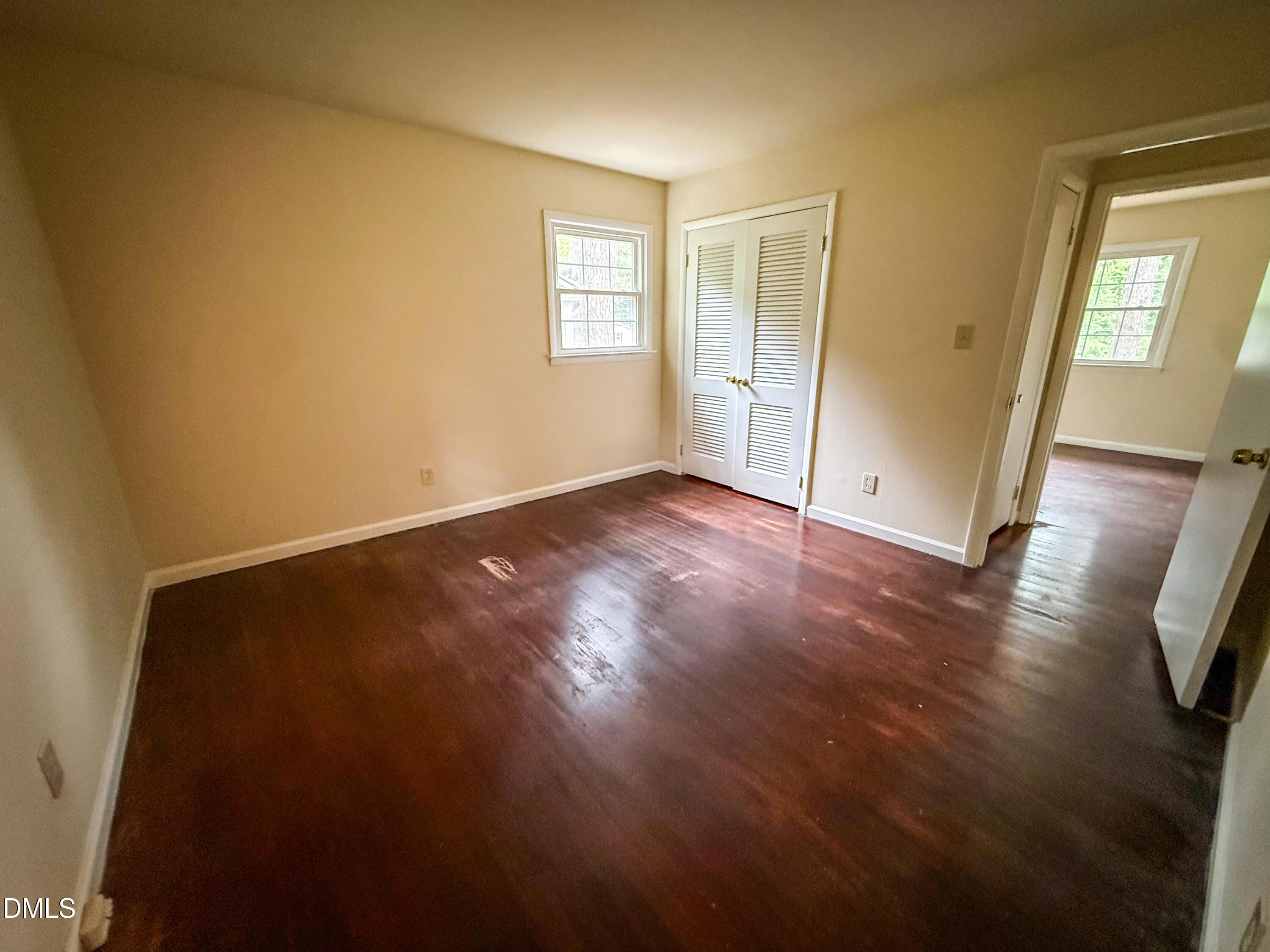 4717 Radcliff Road Raleigh, NC 27609 - Photo 9 of 11 an empty room with wooden floor and windows