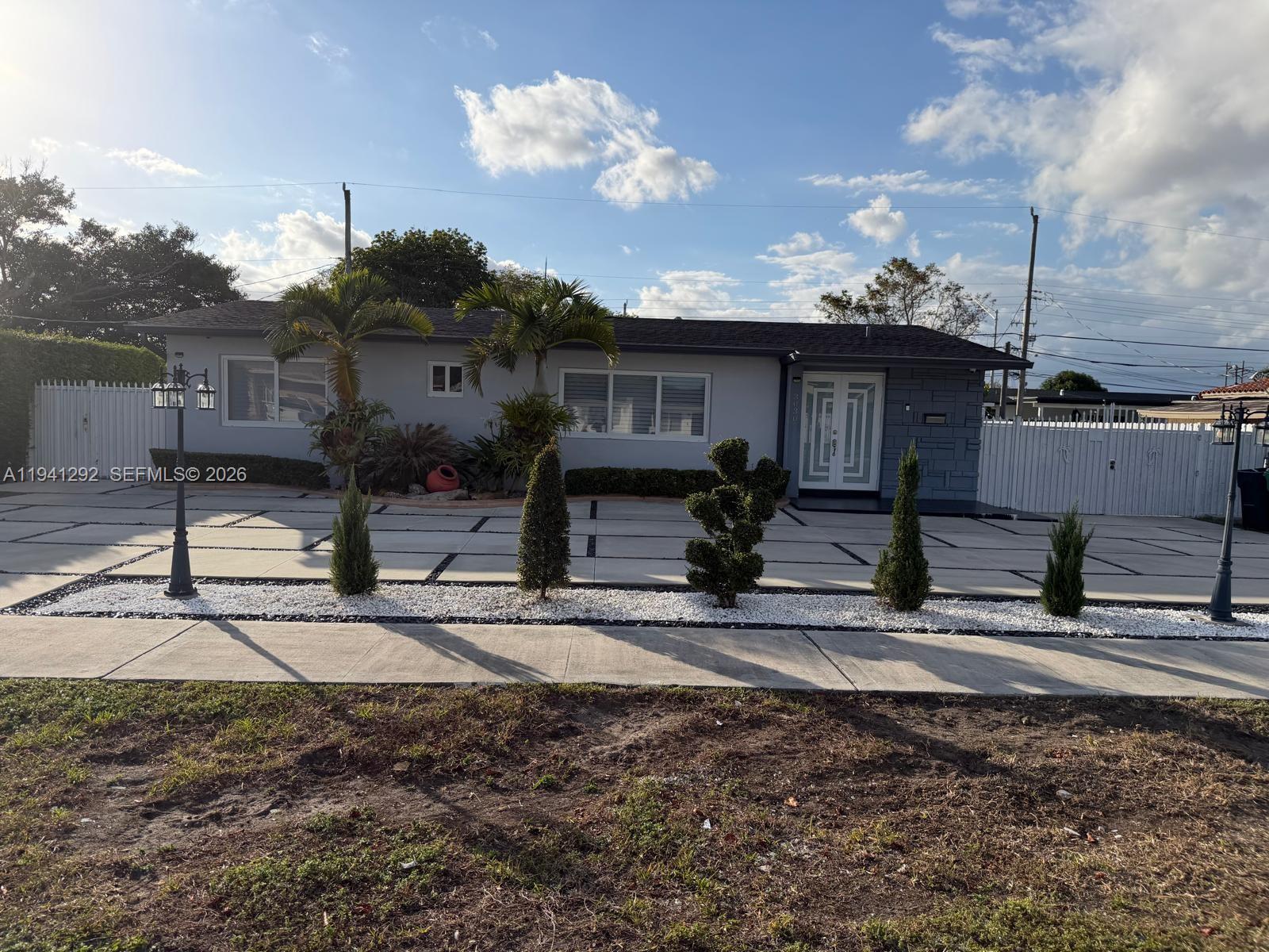 a front view of a house with garden