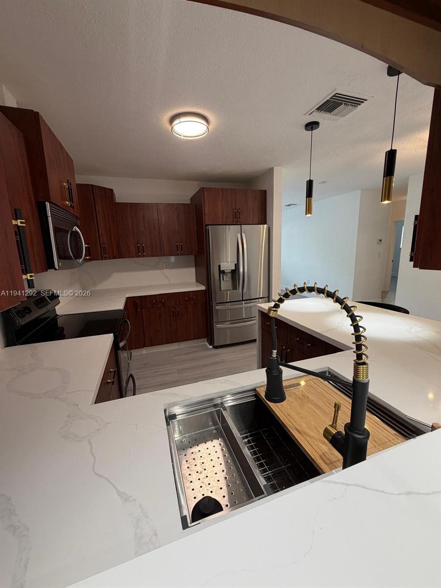 3030 Southwest 96th Avenue Miami, FL 33165 - Photo 12 of 33 a living room with furniture and a flat screen tv