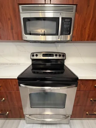 a stove top oven sitting inside of a kitchen