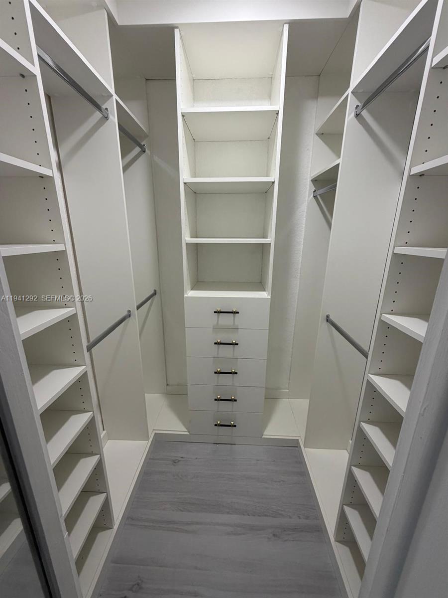 3030 Southwest 96th Avenue Miami, FL 33165 - Photo 22 of 33 a view of walk in closet with wooden floor and stairs