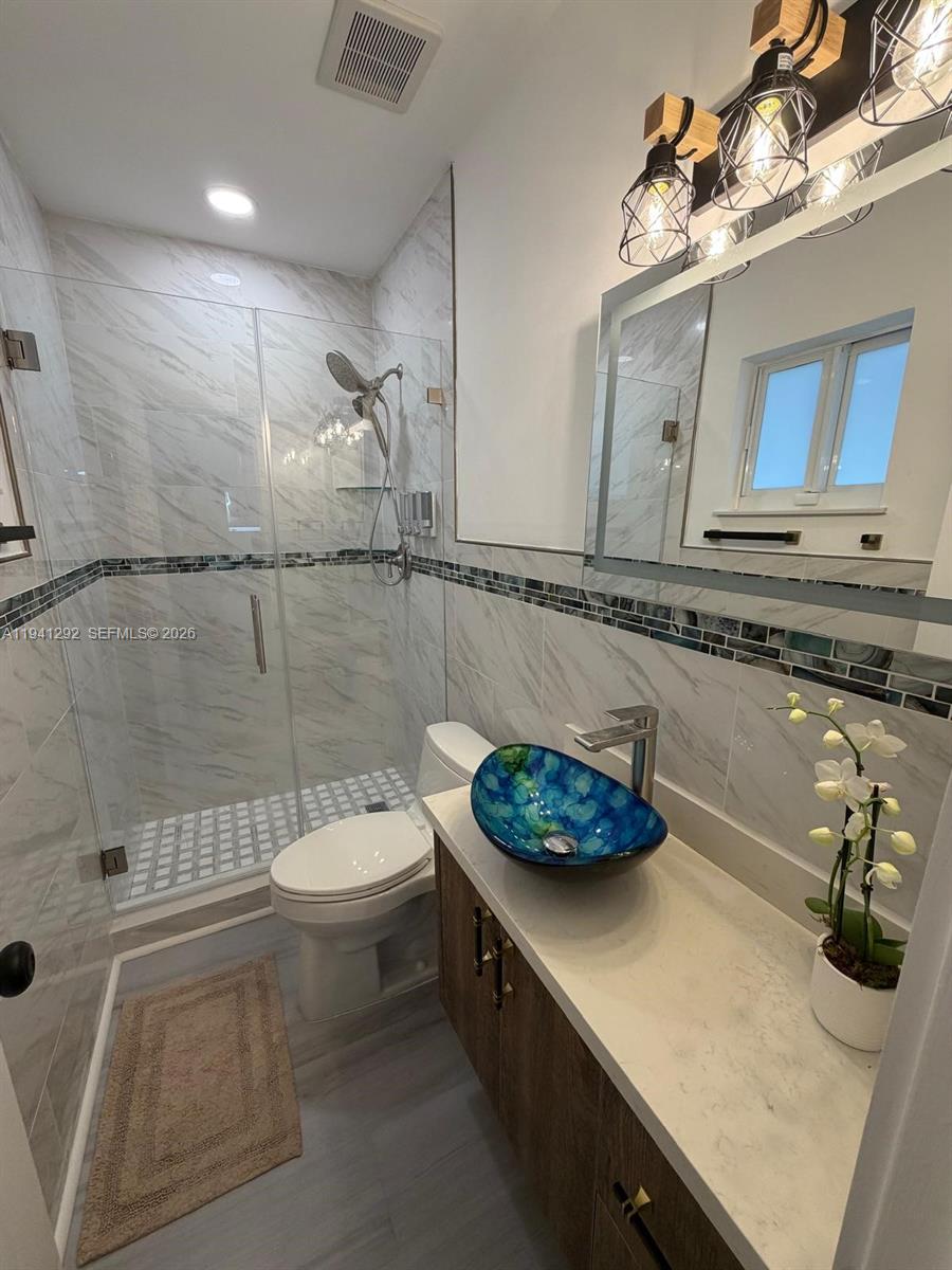 3030 Southwest 96th Avenue Miami, FL 33165 - Photo 23 of 33 a bathroom with a sink a toilet and shower