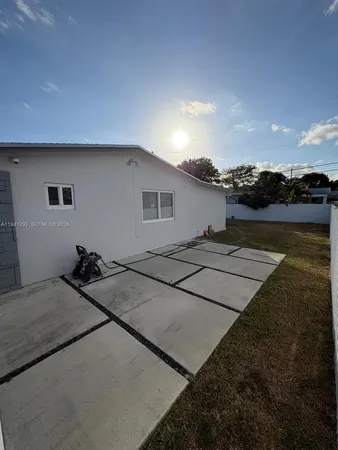 a backyard of a house with lake view and a floor to ceiling window