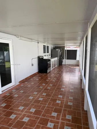 a view of a livingroom with a kitchen