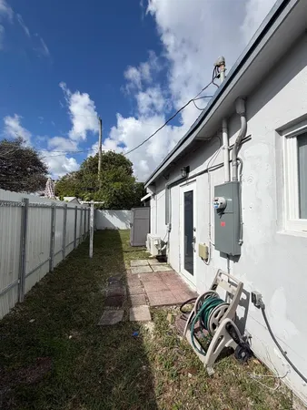a view of a backyard with chair and table
