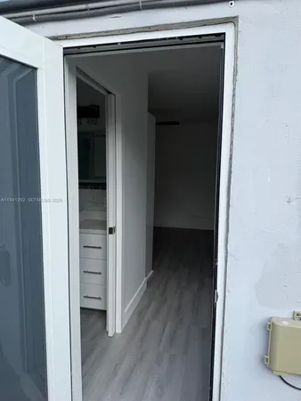 a view of a hallway with wooden floor