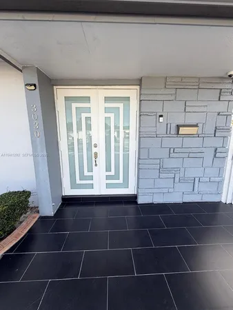 a bathroom with a glass door shower and a sink