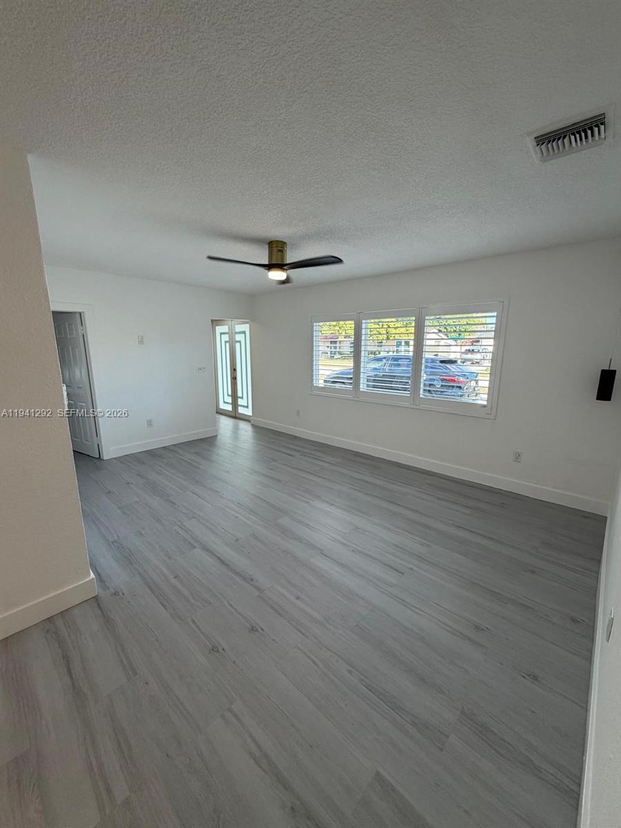 3030 Southwest 96th Avenue Miami, FL 33165 - Photo 8 of 33 an empty room with wooden floor and windows