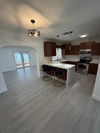 a view of a livingroom with furniture wooden floor and chandelier