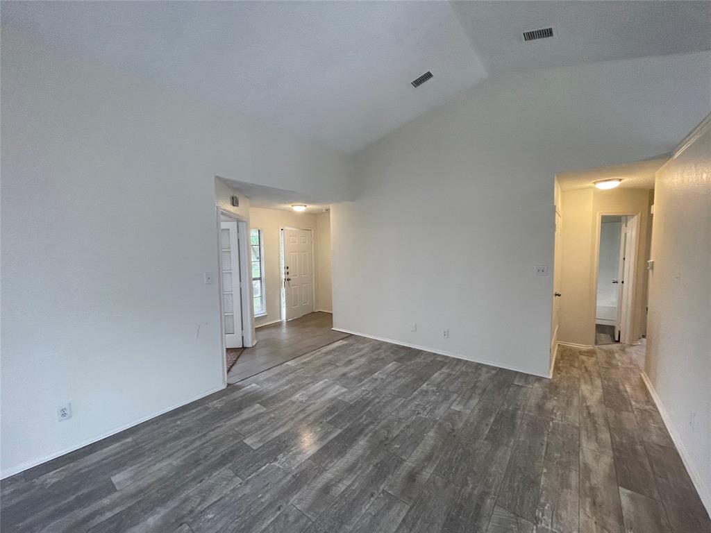9415 Rutherglen Drive Dallas, TX 75227 - Photo 10 of 18 a view of an empty room with wooden floor