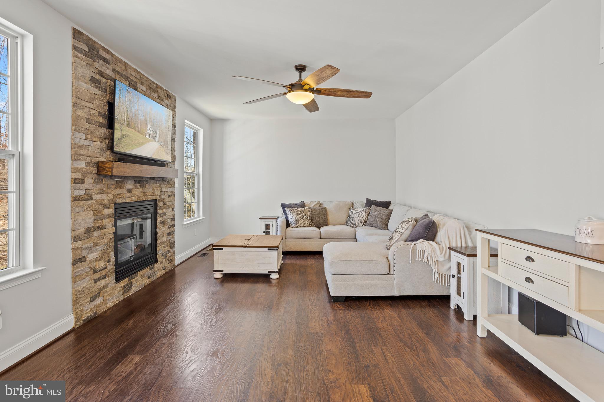 4335 Pleasant Court Huntingtown, MD 20639 - Photo 11 of 46 a living room with furniture fireplace and wooden floor