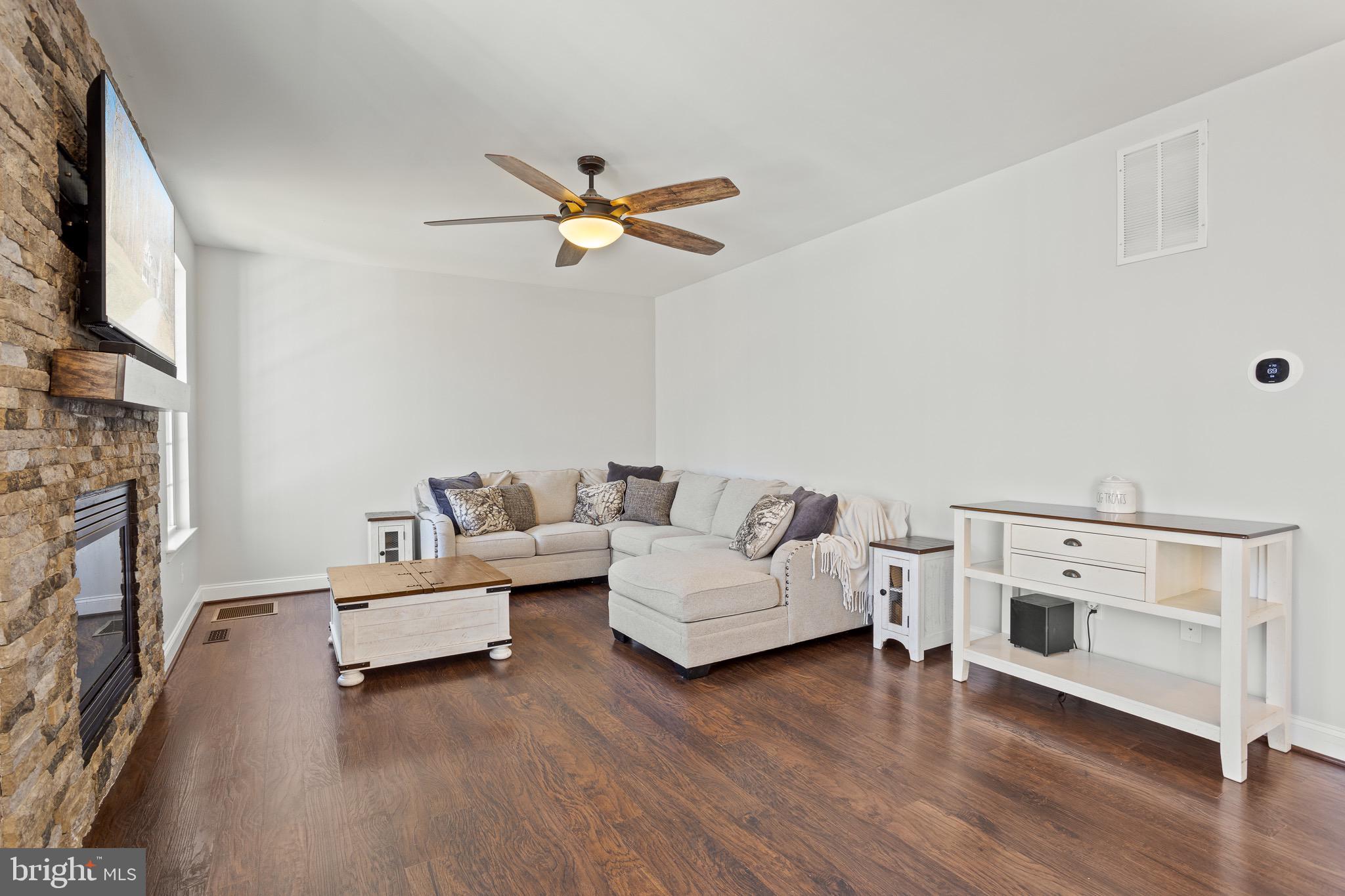 4335 Pleasant Court Huntingtown, MD 20639 - Photo 13 of 46 a living room with furniture and a fireplace