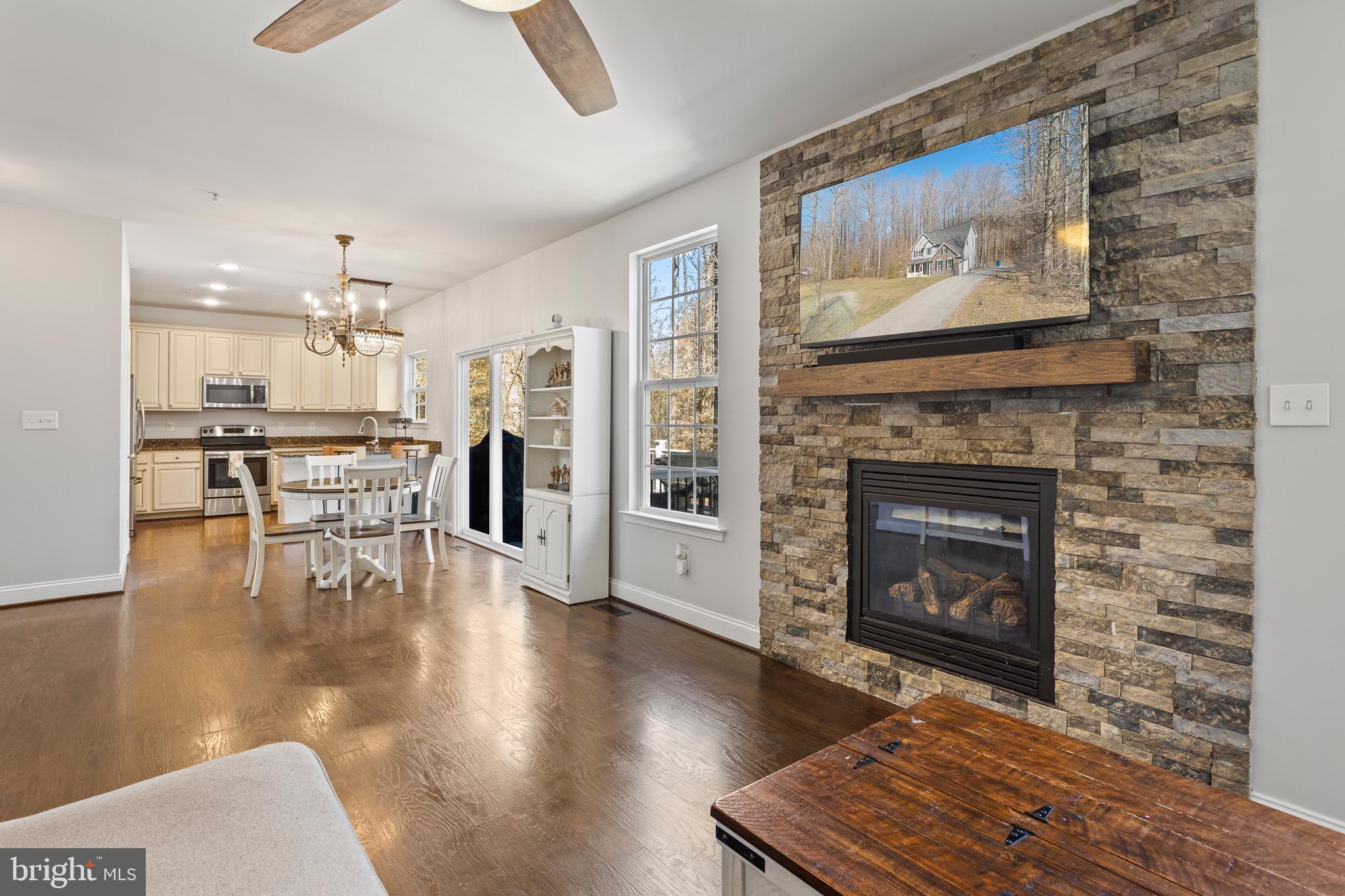 4335 Pleasant Court Huntingtown, MD 20639 - Photo 14 of 46 a living room with furniture and a fireplace