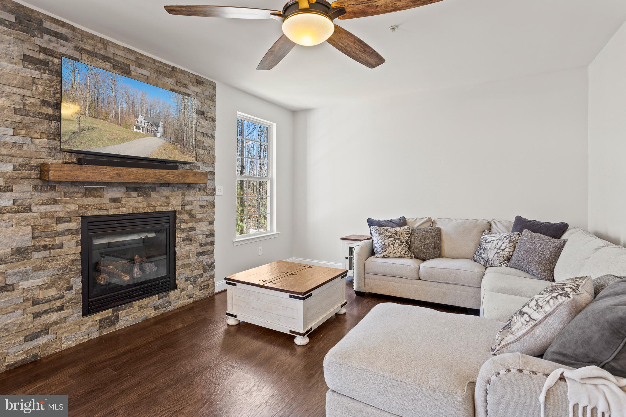 4335 Pleasant Court Huntingtown, MD 20639 - Photo 16 of 46 a living room with furniture and a fireplace