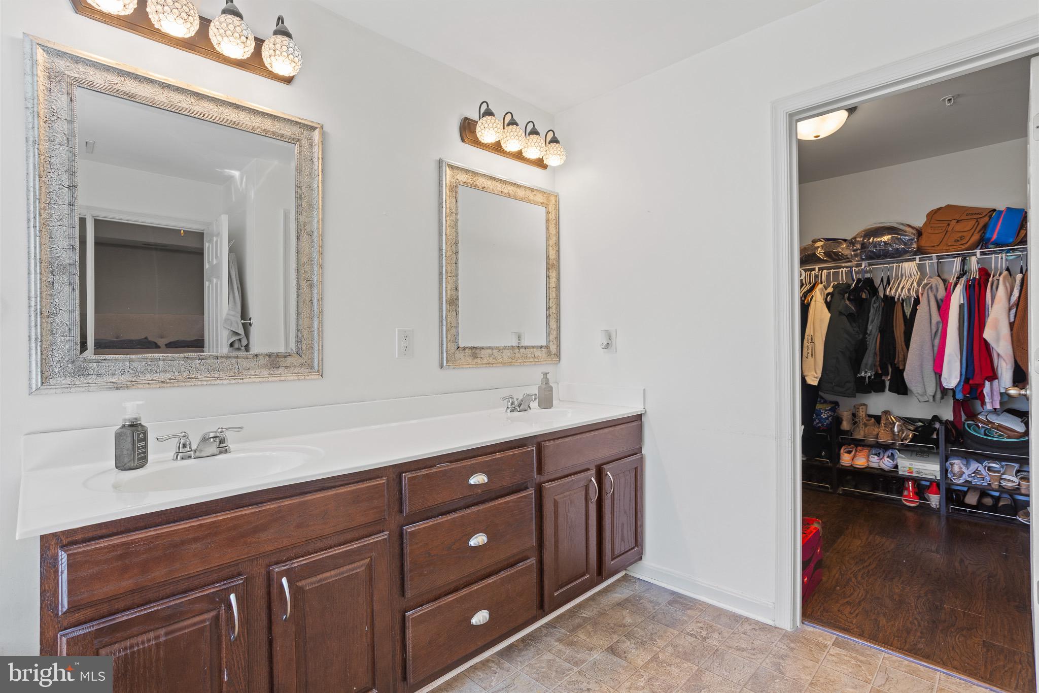 4335 Pleasant Court Huntingtown, MD 20639 - Photo 21 of 46 a bathroom with a double vanity sink and a mirror