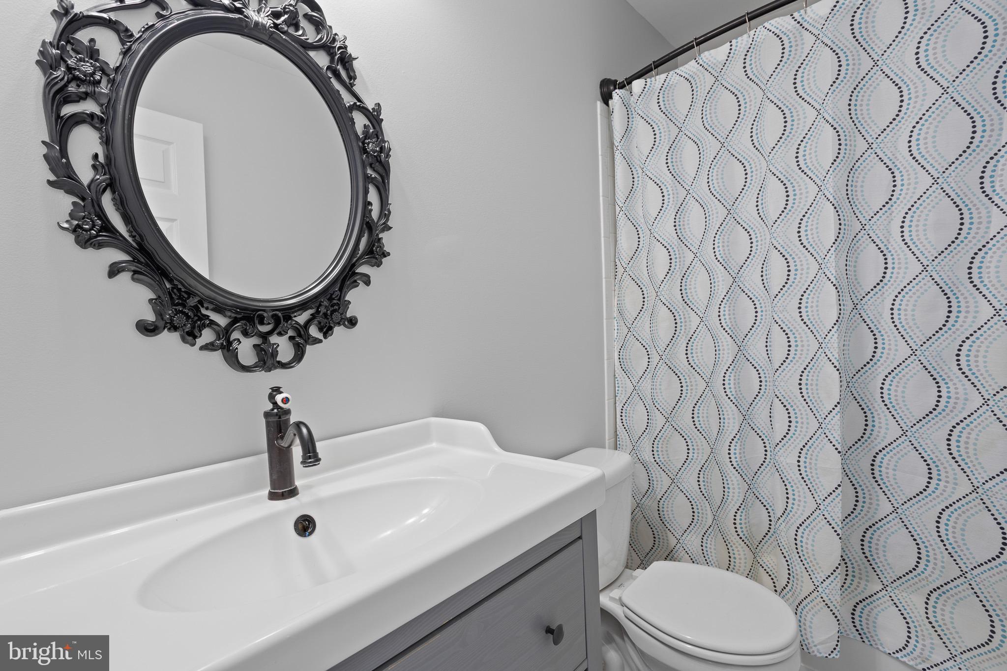 4335 Pleasant Court Huntingtown, MD 20639 - Photo 27 of 46 a bathroom with a sink and a mirror