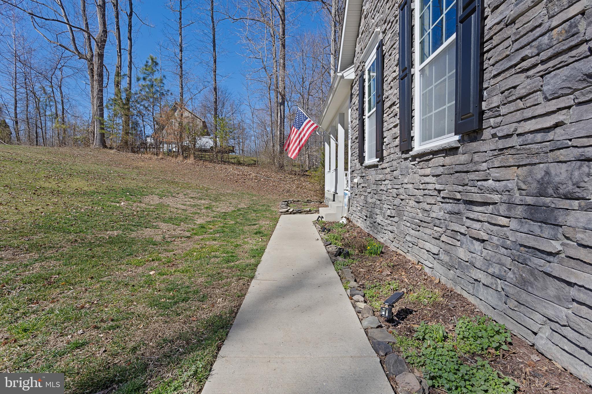 4335 Pleasant Court Huntingtown, MD 20639 - Photo 39 of 46 a view of a pathway with a house in the background with sitting area