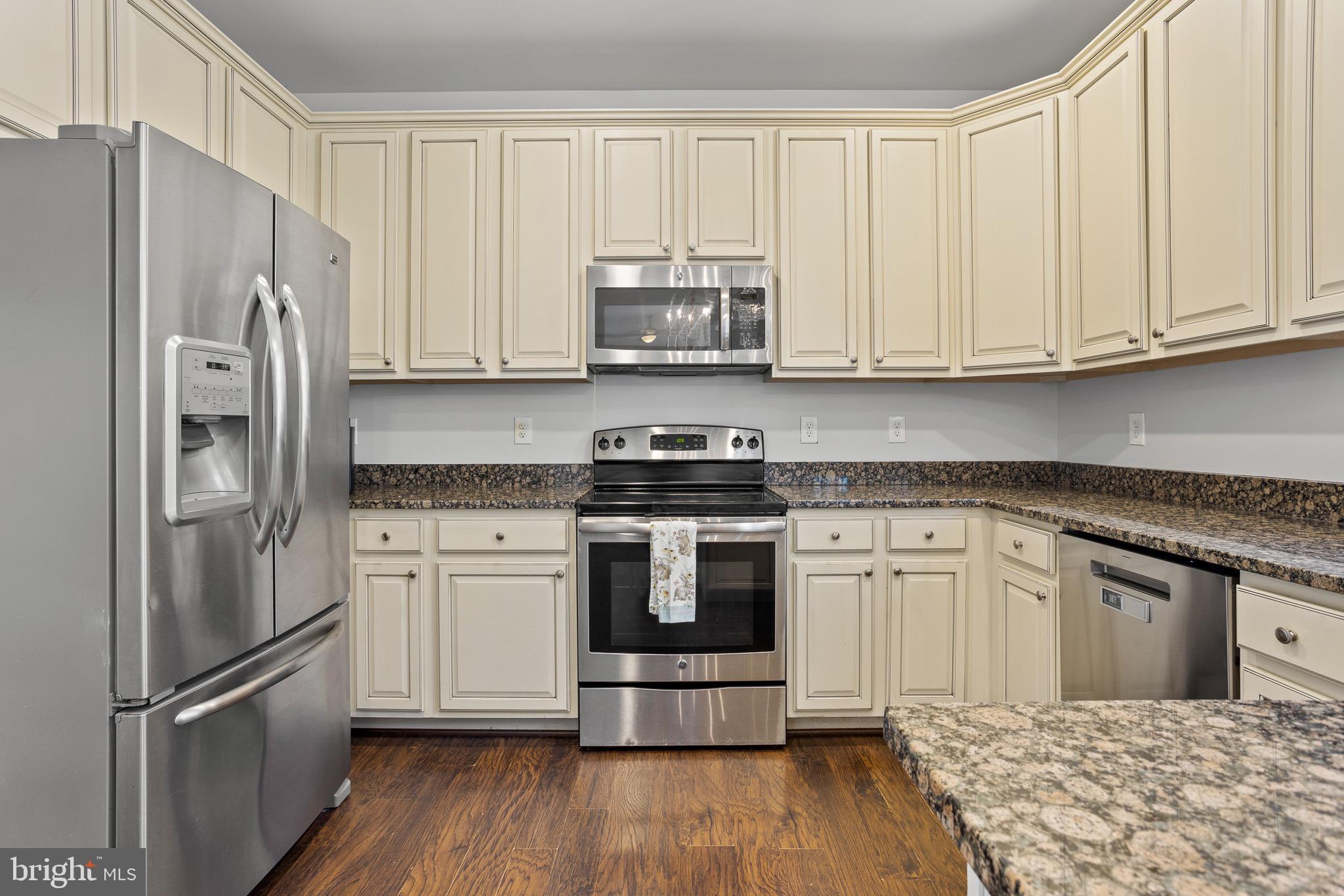 4335 Pleasant Court Huntingtown, MD 20639 - Photo 6 of 46 a kitchen with stainless steel appliances granite countertop a refrigerator stove and white cabinets