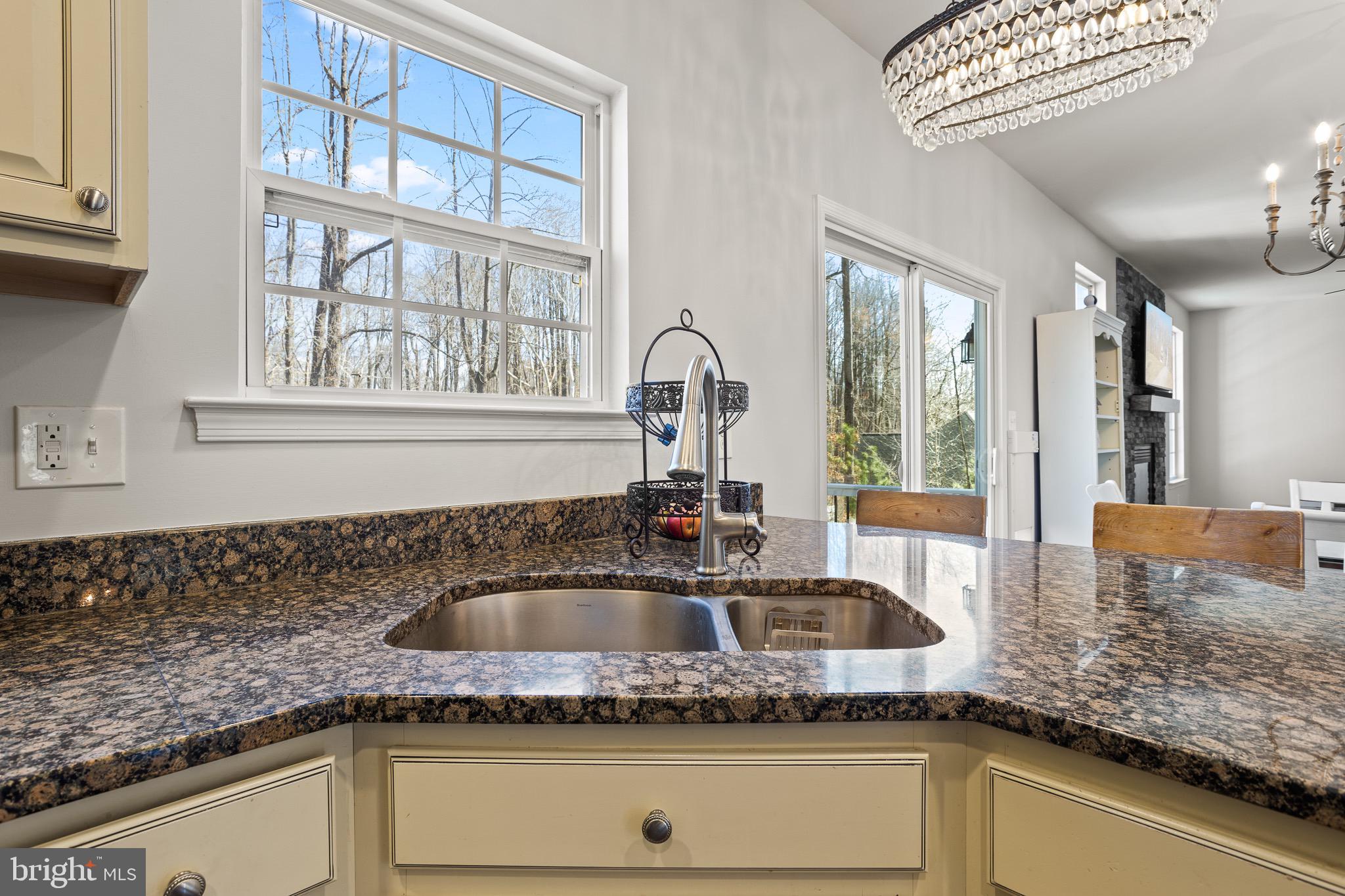 4335 Pleasant Court Huntingtown, MD 20639 - Photo 8 of 46 a kitchen with granite countertop a sink and a window