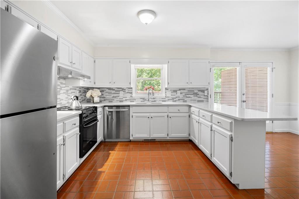 661 North Parkwood Road, Unit C Decatur, GA 30030 - Photo 7 of 14 a kitchen with stainless steel appliances a sink cabinets and a window