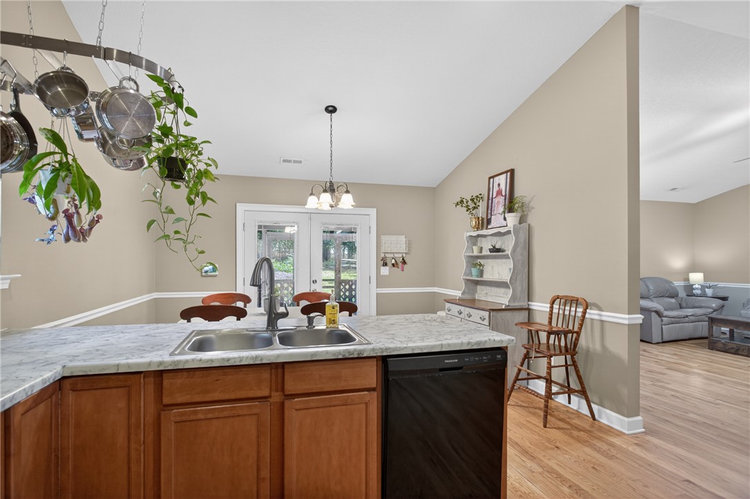 151 Towne Creek Trail Anderson, SC 29621 - Photo 10 of 49 A well-equipped kitchen features a dual basin sink and stylish wood cabinets, with a dining area accessible through French doors.