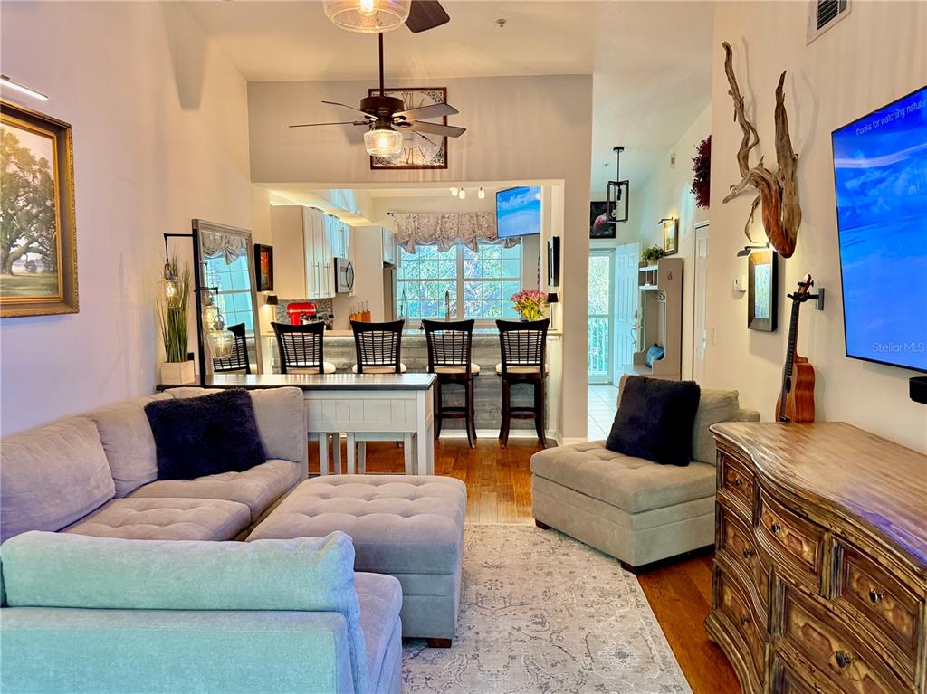 100 San Juan Drive, Unit A203 Palm Coast, FL 32137 - Photo 11 of 59 a living room with furniture and a chandelier