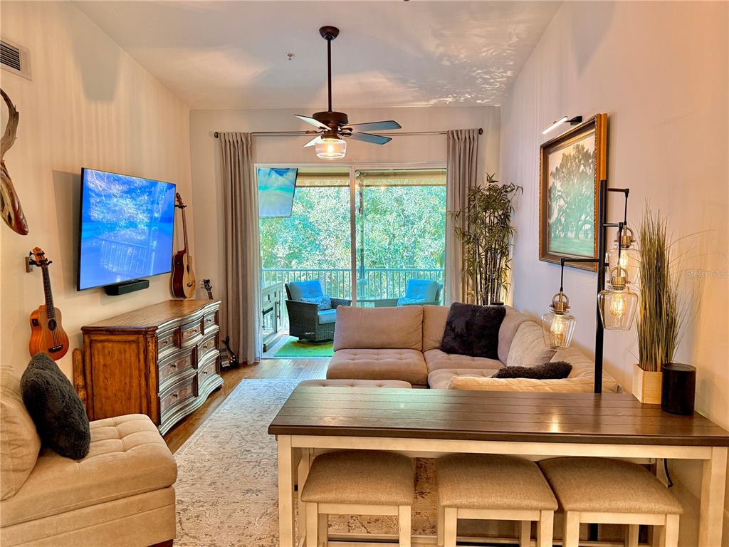 100 San Juan Drive, Unit A203 Palm Coast, FL 32137 - Photo 13 of 59 a living room with furniture and a flat screen tv