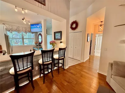a dining room with furniture window and wooden floor
