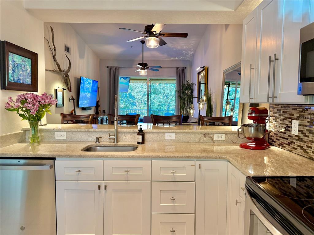 100 San Juan Drive, Unit A203 Palm Coast, FL 32137 - Photo 20 of 59 a kitchen with a sink and a refrigerator