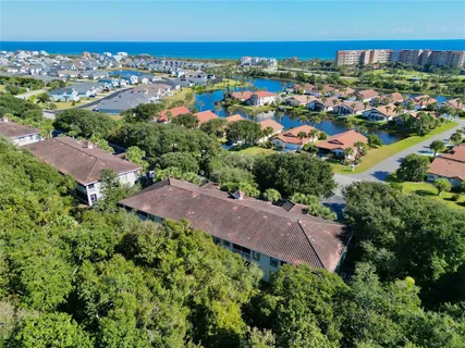 an aerial view of residential houses with outdoor space and trees