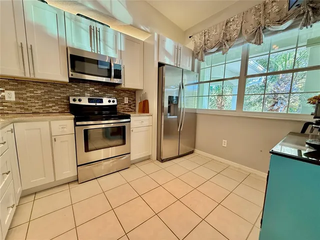 a kitchen with stainless steel appliances a stove a sink and a microwave
