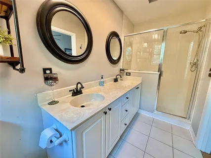 a bathroom with a double vanity sink and a mirror