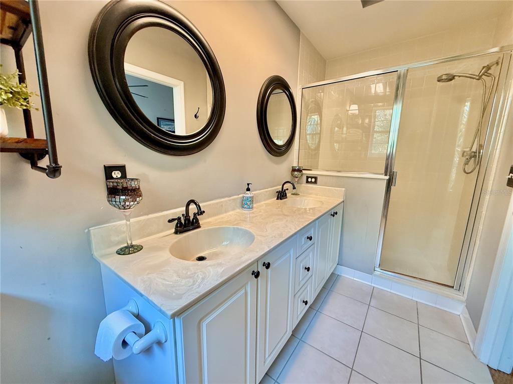 100 San Juan Drive, Unit A203 Palm Coast, FL 32137 - Photo 30 of 59 a bathroom with a double vanity sink and a mirror