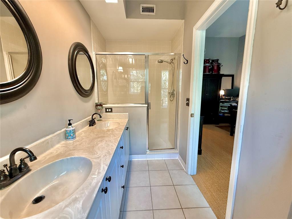 100 San Juan Drive, Unit A203 Palm Coast, FL 32137 - Photo 32 of 59 a bathroom with a granite countertop sink and a mirror