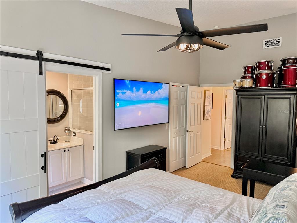 100 San Juan Drive, Unit A203 Palm Coast, FL 32137 - Photo 36 of 59 a bedroom with a bed and a chandelier