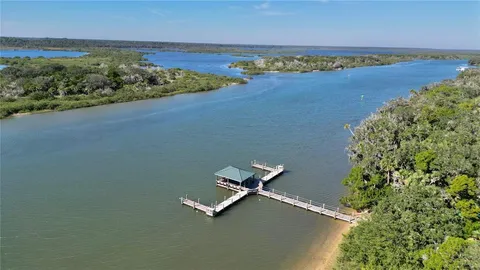 a front view of a house with yard porch and furniture