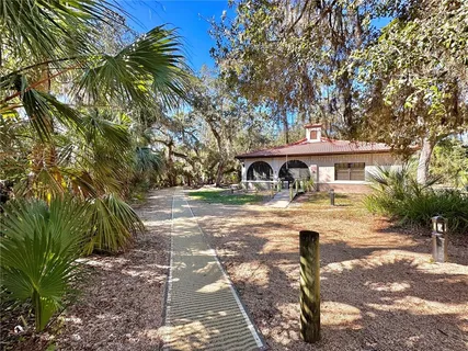 a yellow and red car parked in front of a house