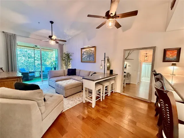 a living room with furniture a window and a flat screen tv