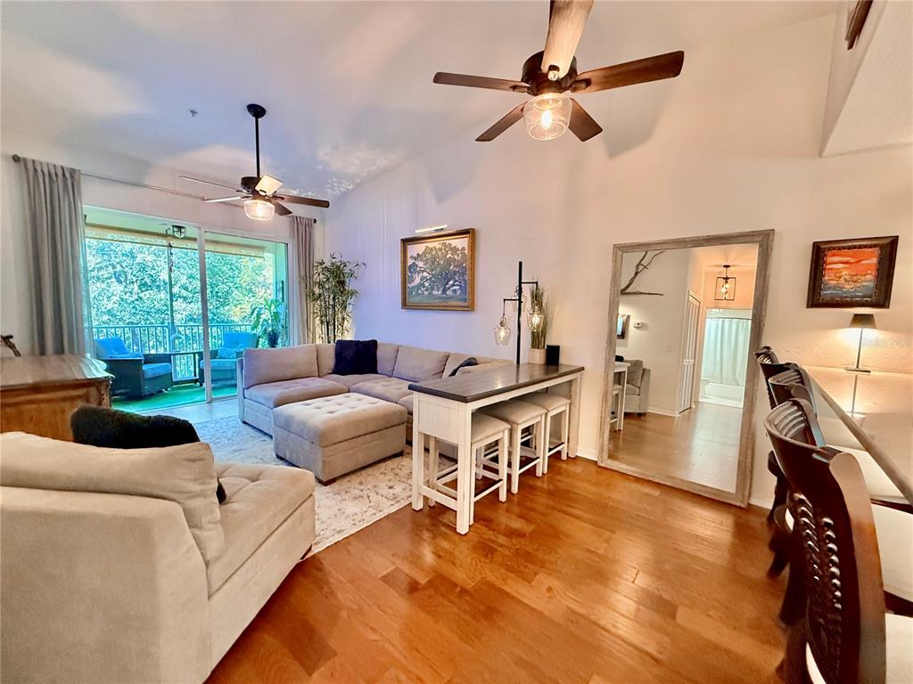 100 San Juan Drive, Unit A203 Palm Coast, FL 32137 - Photo 9 of 59 a living room with furniture a window and a flat screen tv