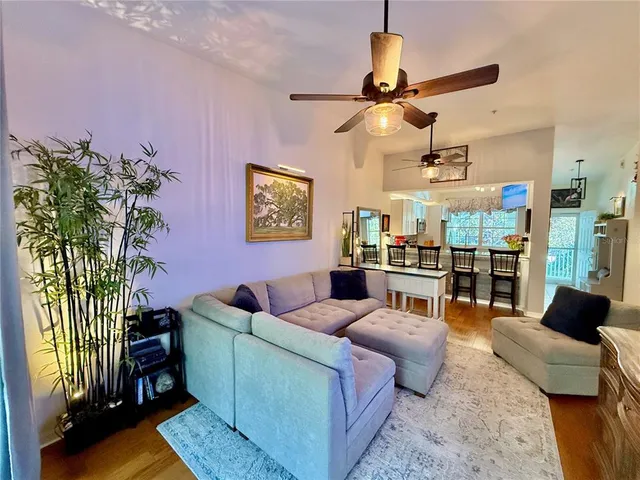 a living room with furniture a chandelier and a window