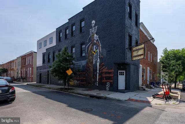 a brick building with a street sign on it
