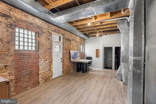 a large building with a couple of cars parked in front of it