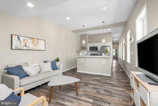 a bedroom with a bed and a potted plant next to a window