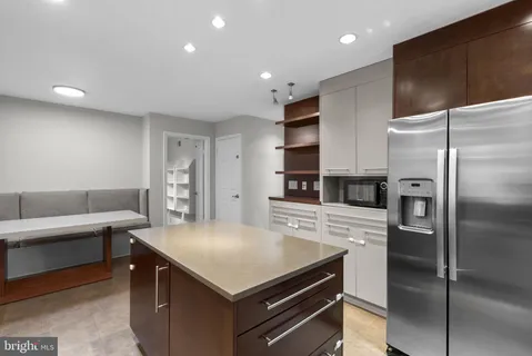 a large kitchen with stainless steel appliances granite countertop a large counter top and a stove