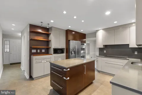 a kitchen with a sink stainless steel appliances and cabinets