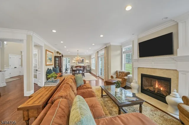 a kitchen with stainless steel appliances granite countertop a stove top oven a dining table and chairs with wooden floor